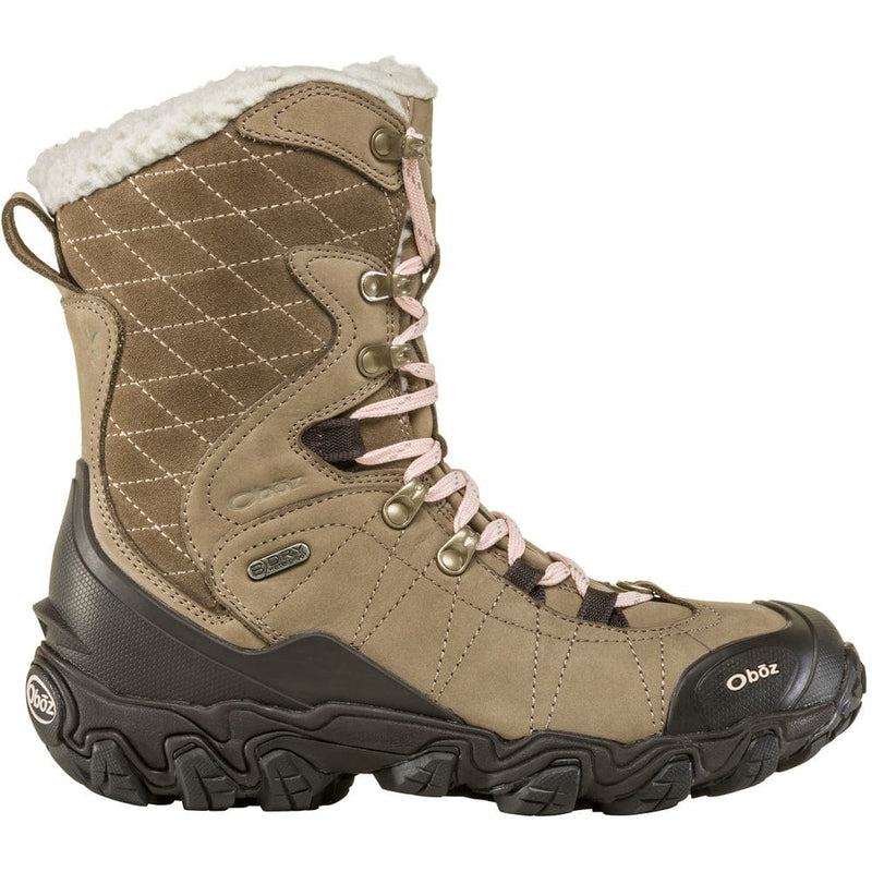 Load image into Gallery viewer, A woman's insulated hiking boot with a brown nubuck leather upper, waterproof membrane, and a black rubber outsole. It features pink lace hooks and a quilted design on the side.