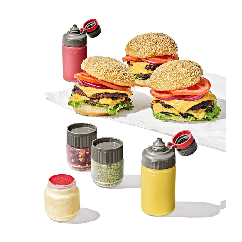 Load image into Gallery viewer, Three burgers with various condiments and a set of small containers on a white background