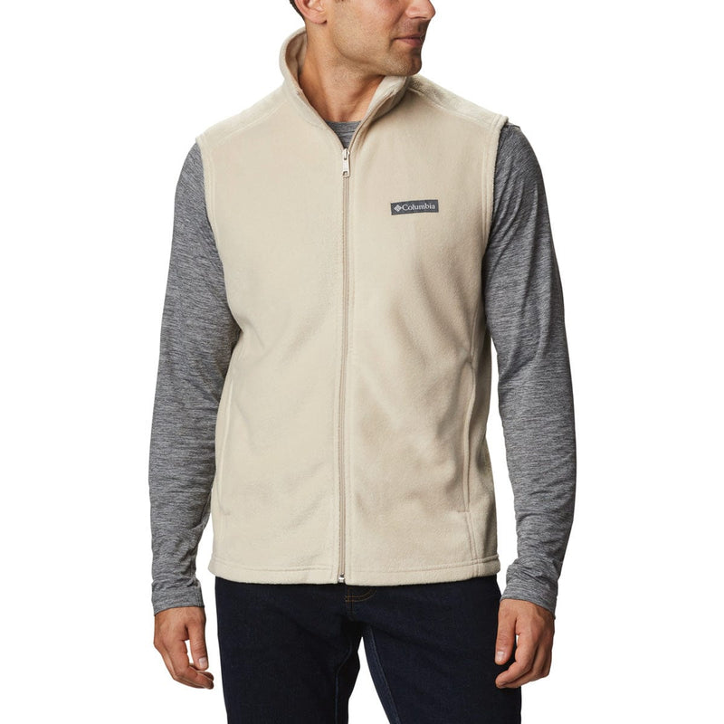 Load image into Gallery viewer, Man wearing a beige fleece vest with Columbia logo on a white background