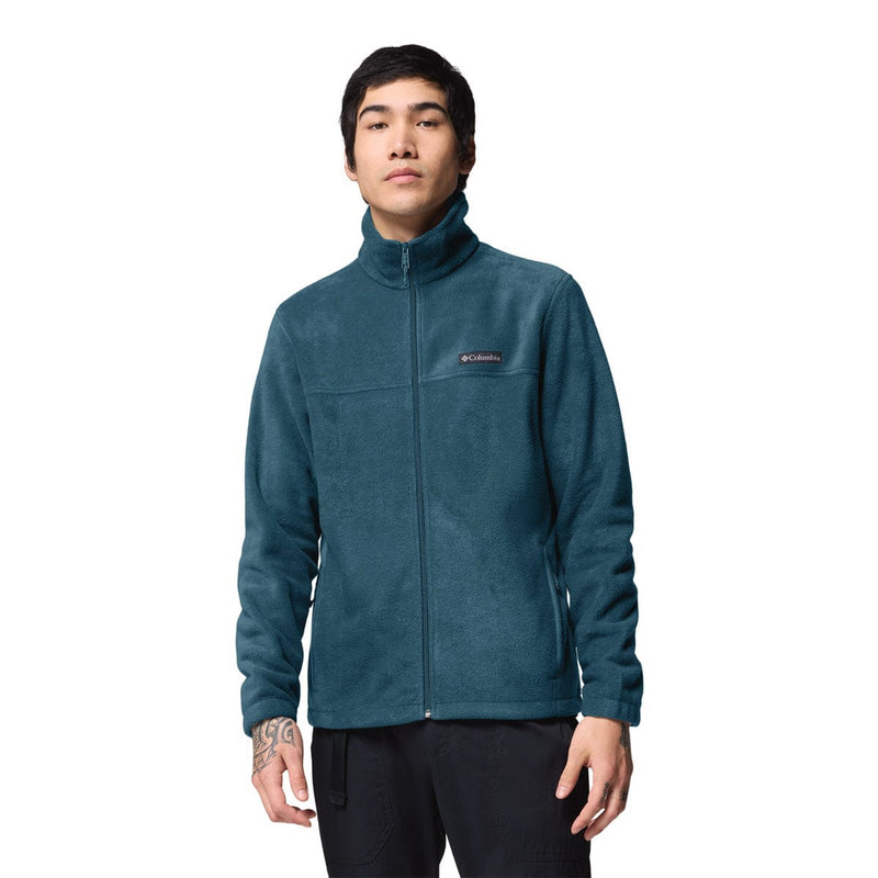 Load image into Gallery viewer, Person wearing a teal fleece jacket with Columbia logo on a white background