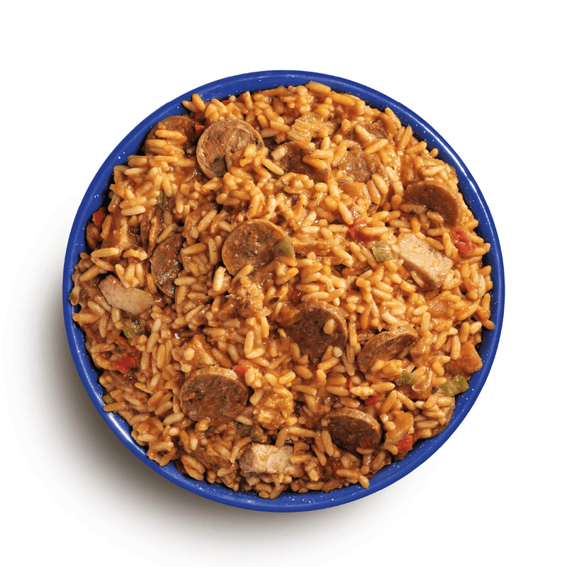 Load image into Gallery viewer, Bowl of jambalaya with sausage and vegetables on a white background
