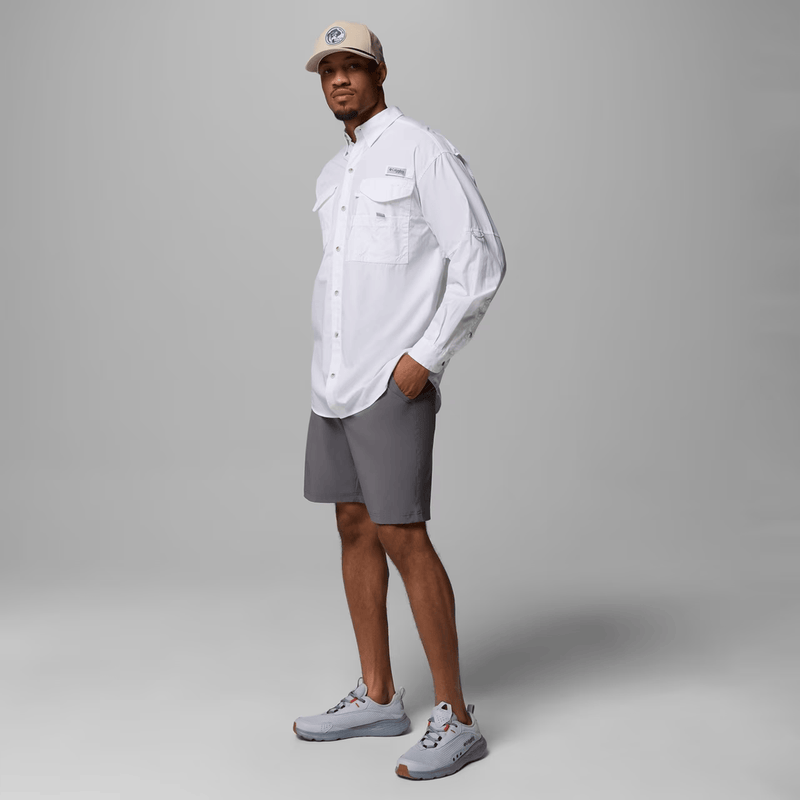 Load image into Gallery viewer, Person wearing a white shirt, gray shorts, and a beige cap on a gray background