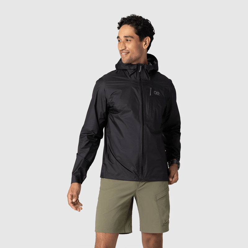 Load image into Gallery viewer, Man wearing a black jacket and green shorts on a light gray background