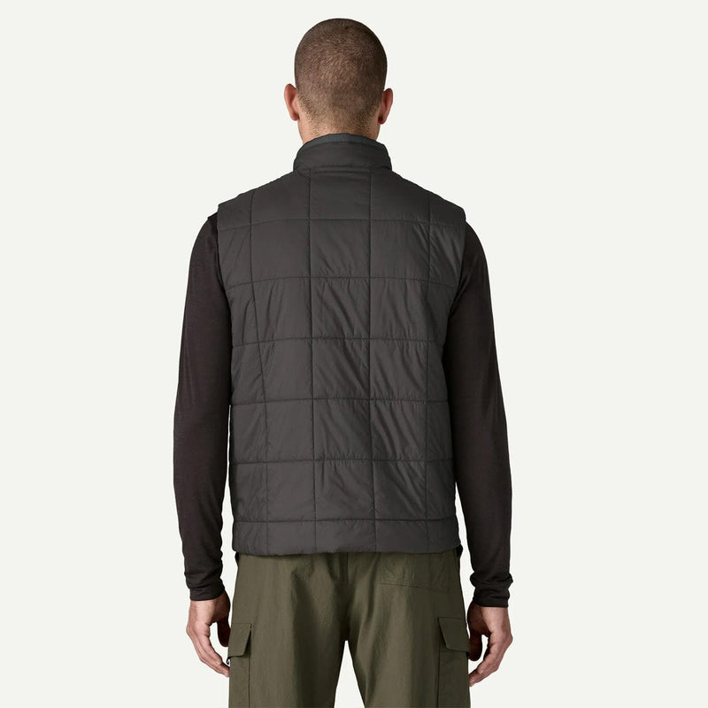 Load image into Gallery viewer, Man wearing a dark gray quilted vest on a white background
