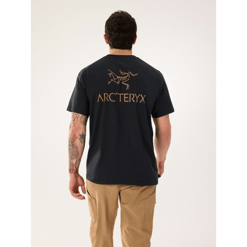 Load image into Gallery viewer, Person wearing a black t-shirt with Arc'teryx logo on the back, standing against a white background