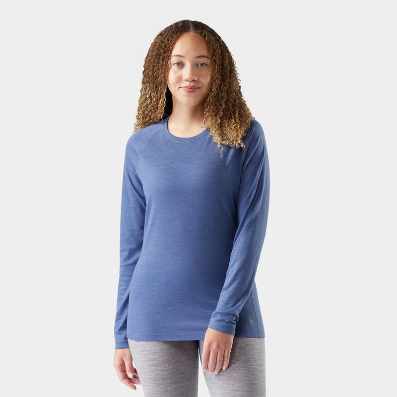 Load image into Gallery viewer, Woman wearing a blue long-sleeve shirt on a white background