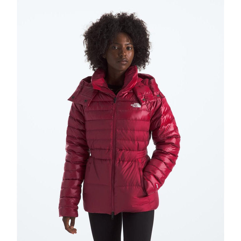 Load image into Gallery viewer, Person wearing a red puffer jacket with a brand logo on a white background