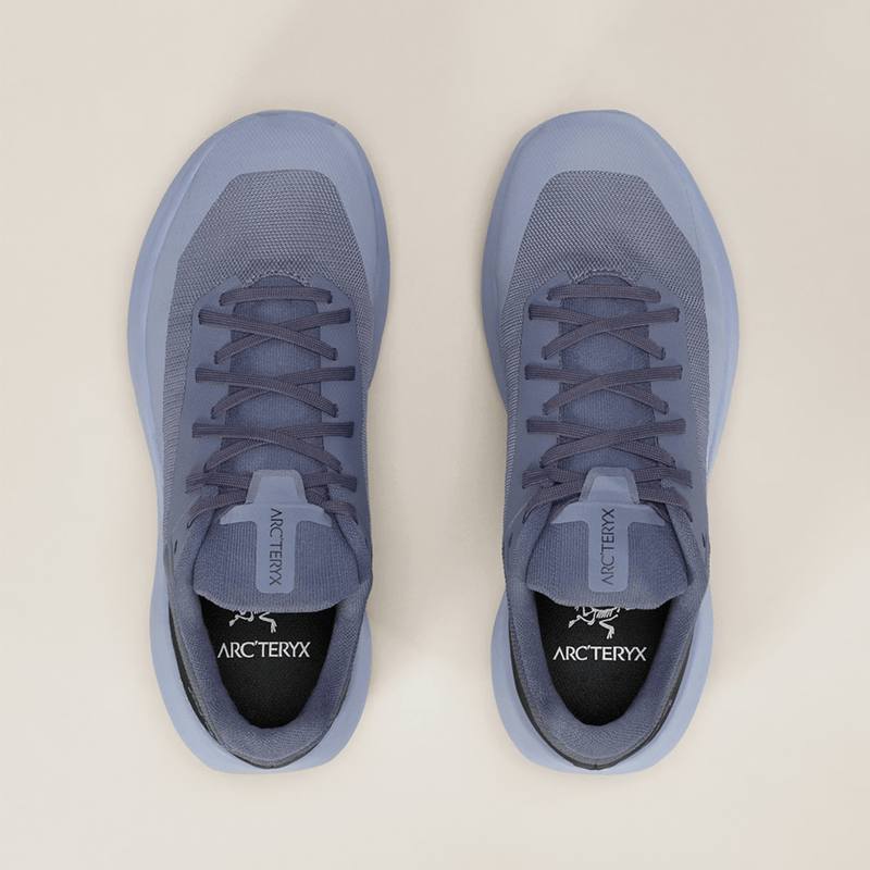 Load image into Gallery viewer, Pair of gray Arcteryx sneakers on a beige background