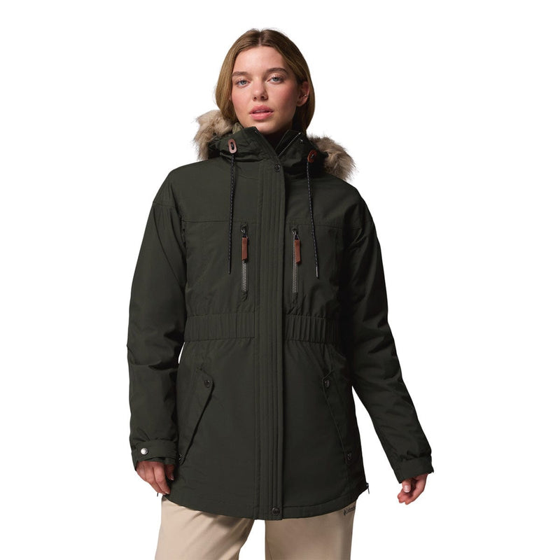 Load image into Gallery viewer, Woman wearing a dark green parka with fur trim on a white background