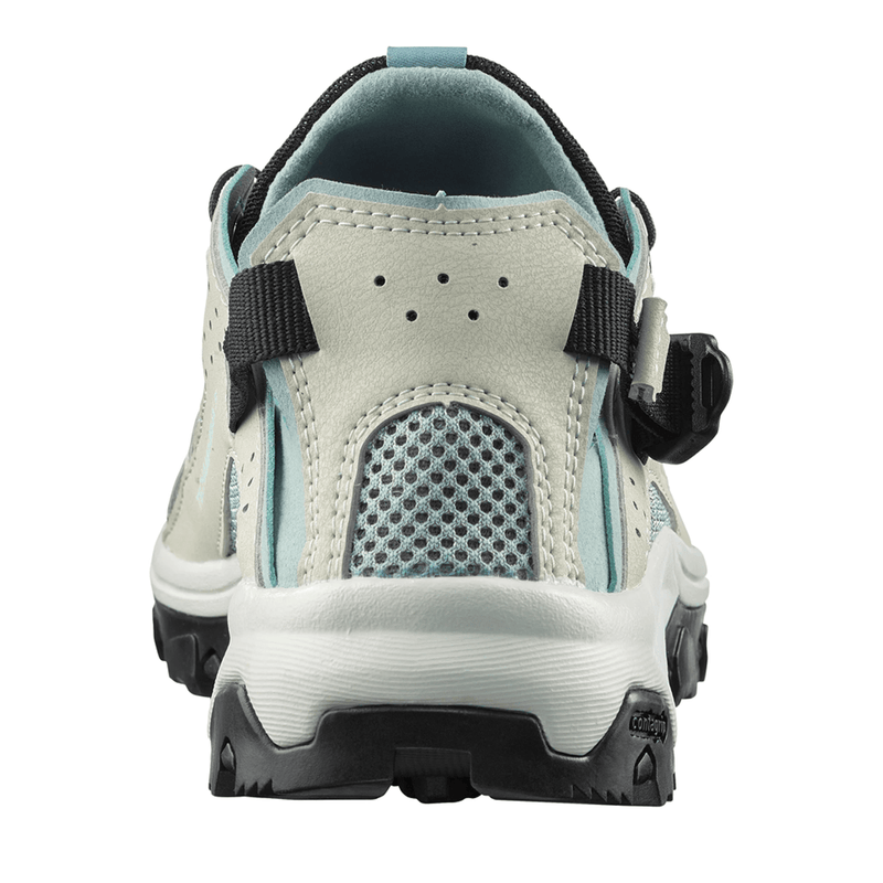 Load image into Gallery viewer, Back view of a light gray sandal with black straps on a white background