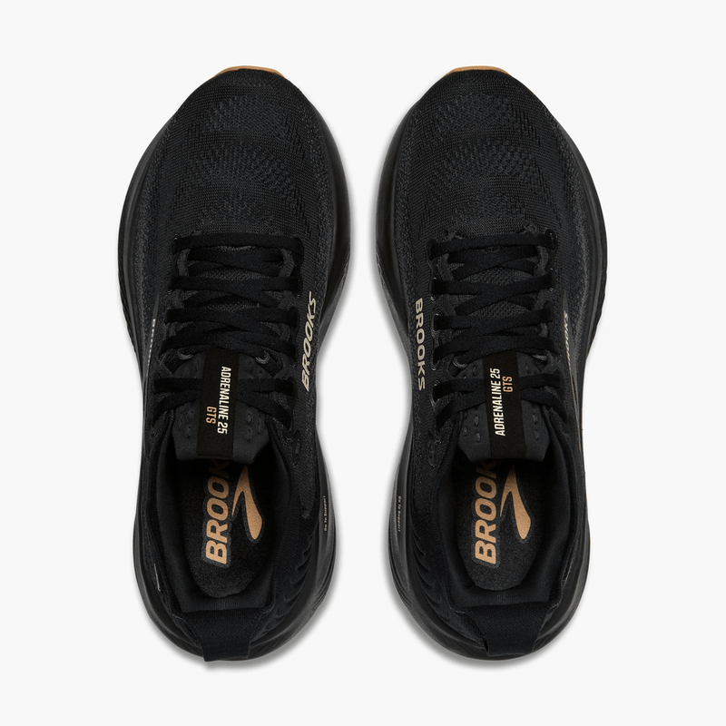 Load image into Gallery viewer, Black running shoes with gold accents on a white background