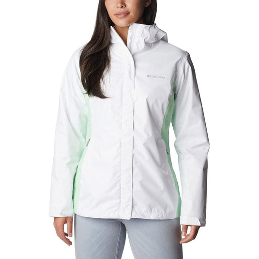 Woman wearing a white jacket with green accents on a white background