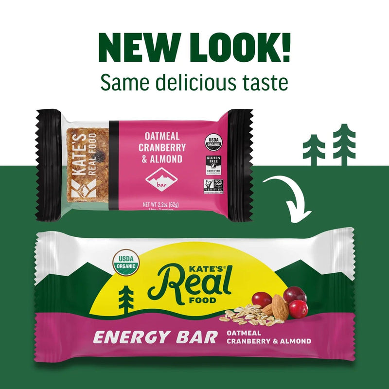 Load image into Gallery viewer, Two versions of Kate's Real Food energy bar packaging with a green background and trees.
