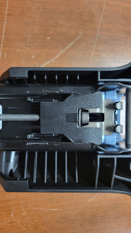 Black plastic component on a wooden surface
