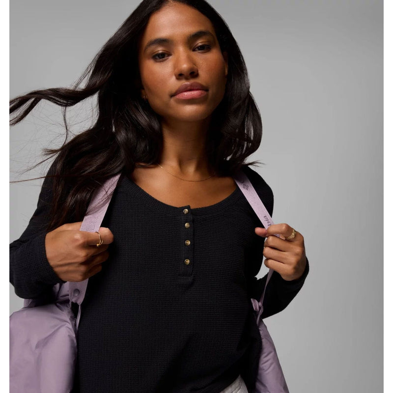 Load image into Gallery viewer, Woman holding a light purple jacket against a gray background

