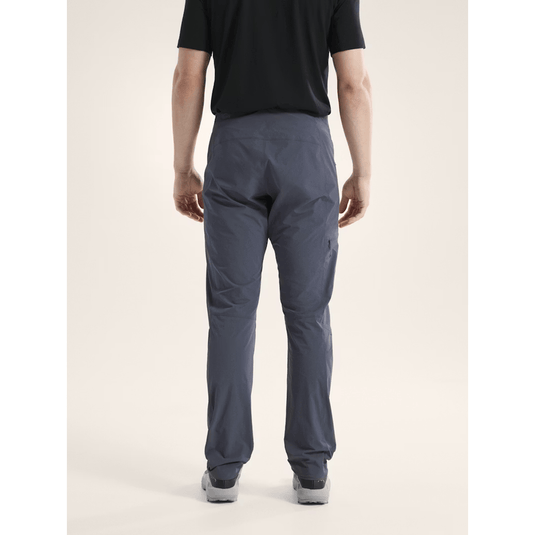 Person wearing dark gray pants on a plain background