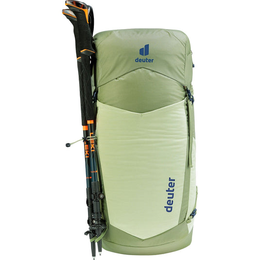 Green hiking backpack with poles attached on a white background