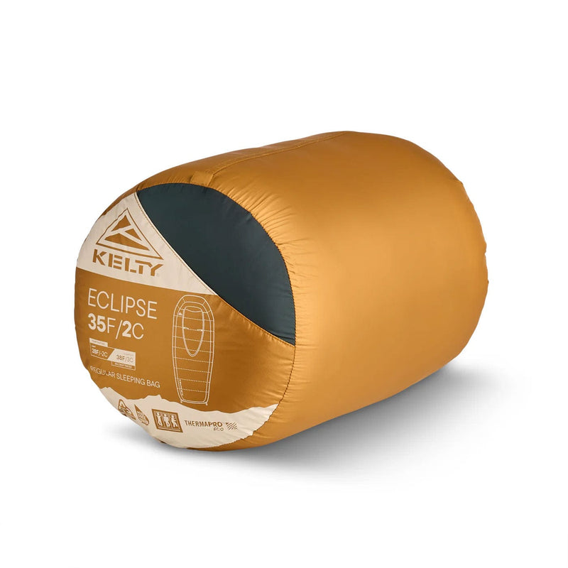 Load image into Gallery viewer, Kelty Eclipse sleeping bag with gold exterior and gray interior on a white background
