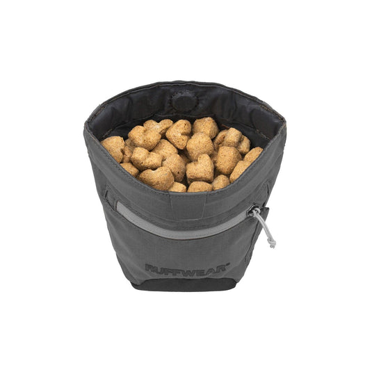 Gray pet food bag filled with kibble on a white background