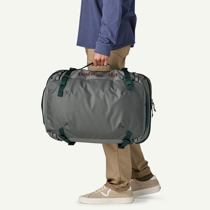 Load image into Gallery viewer, Person holding a gray duffel bag with 'Columbia' branding on a white background
