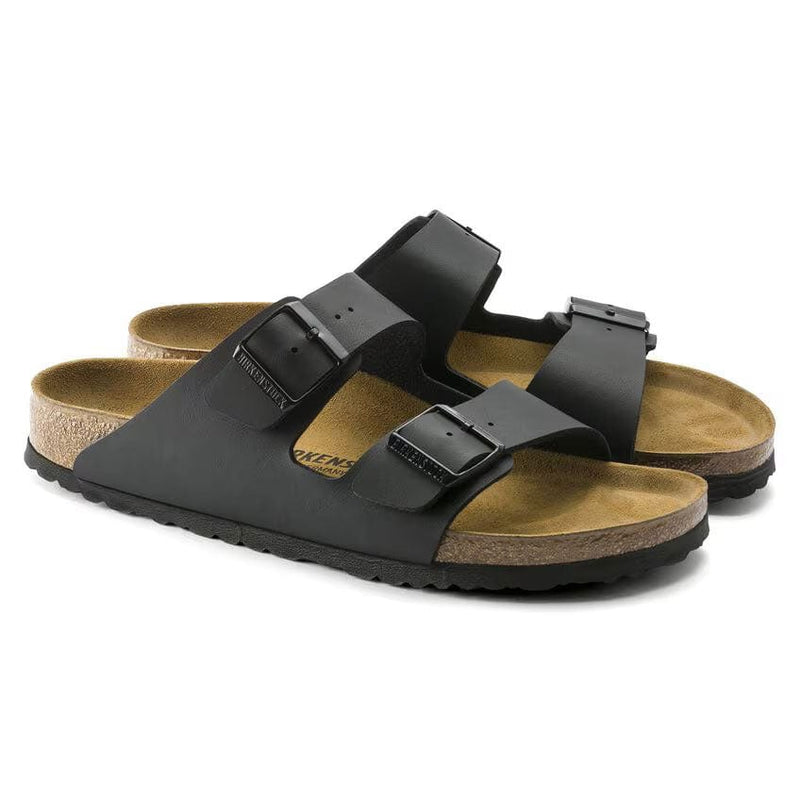 Load image into Gallery viewer, Black sandals with brown soles on a white background
