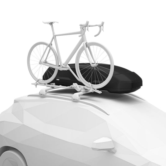White bicycle on a car roof rack with a black cover on a white background