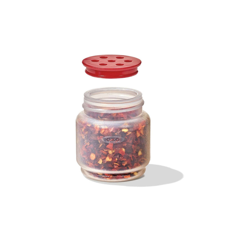 Load image into Gallery viewer, Glass jar with red lid filled with red pepper flakes on a white background
