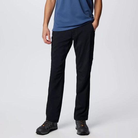 Person wearing black pants and a blue shirt on a white background