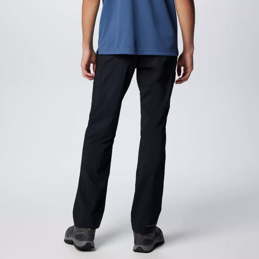 Person wearing black pants and a blue top on a white background
