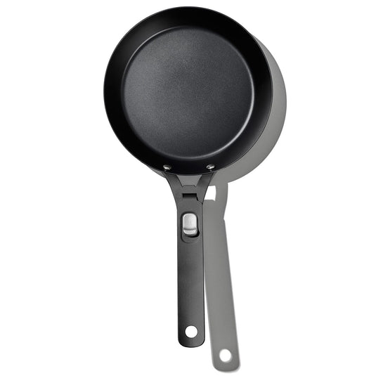 Black frying pan with a handle on a white background