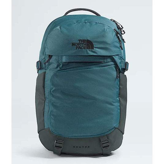 Teal and gray backpack with The North Face logo on a light blue background