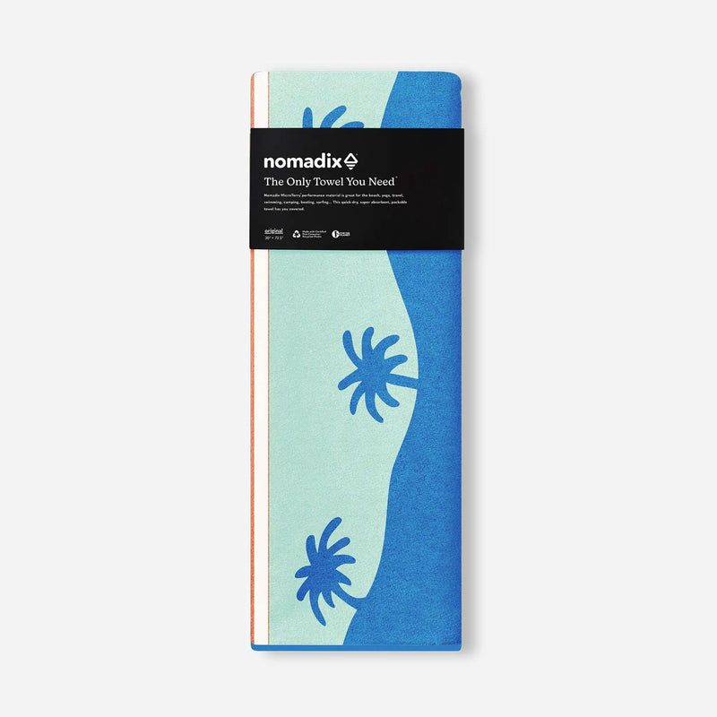 Load image into Gallery viewer, Packaged towel with blue and green design and 'nomadix' branding on a white background
