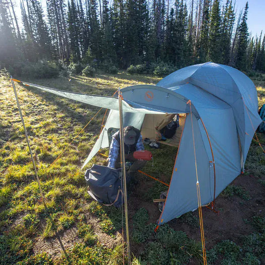Camping scene with a tent set up in a forested area