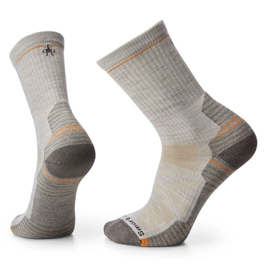 A pair of SmartWool Hike Light Cushion Crew socks in red and black, featuring a crew length and mesh zones on the side.