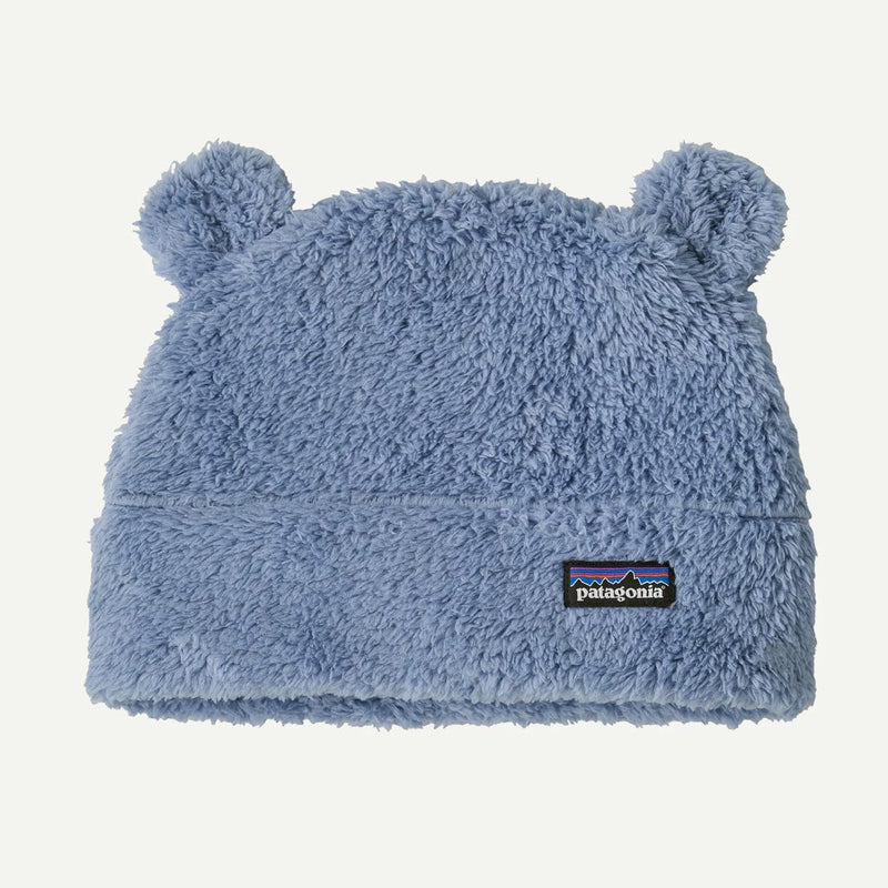 Load image into Gallery viewer, Blue fuzzy baby hat with bear ears and Patagonia logo on a light gray background
