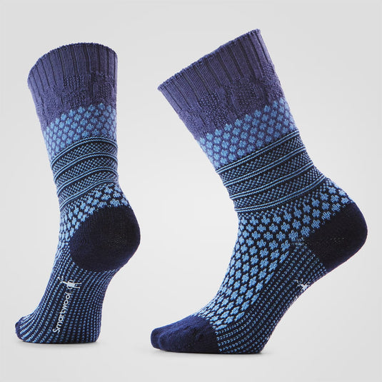 Pair of blue and black patterned socks on a light gray background