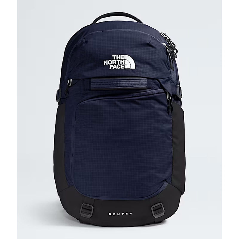 Load image into Gallery viewer, Navy blue backpack with The North Face logo on a light gray background
