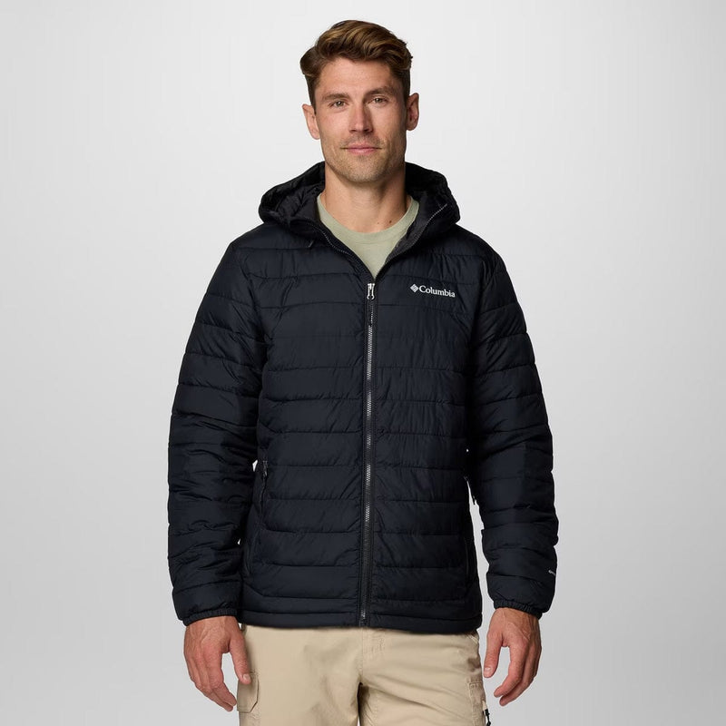 Load image into Gallery viewer, Man wearing a black puffer jacket with Columbia logo on a light gray background
