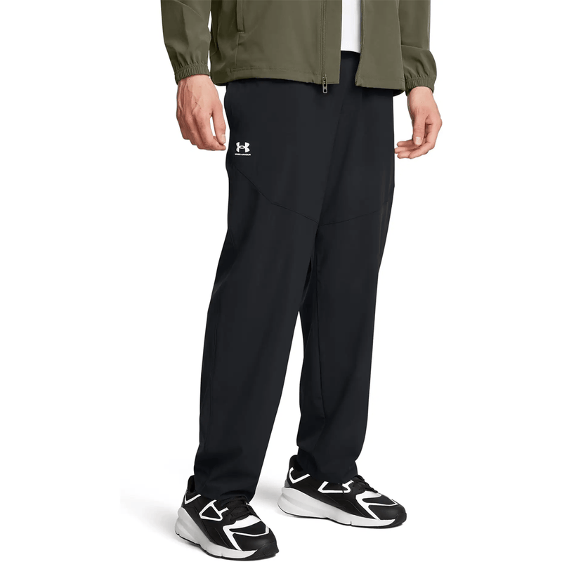 Load image into Gallery viewer, Person wearing black pants with a brand logo on a white background

