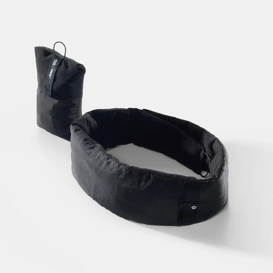 Black travel pillow with packaging on a white background