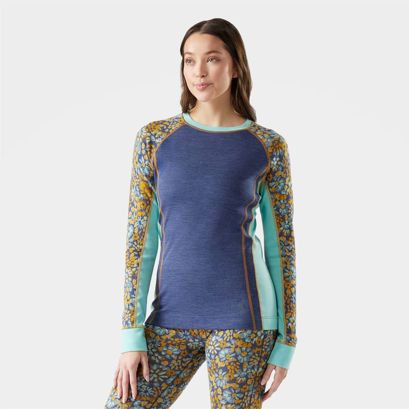 Load image into Gallery viewer, Woman wearing a blue and floral long-sleeve top on a white background
