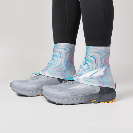 Gray running shoes with colorful socks on a light gray background