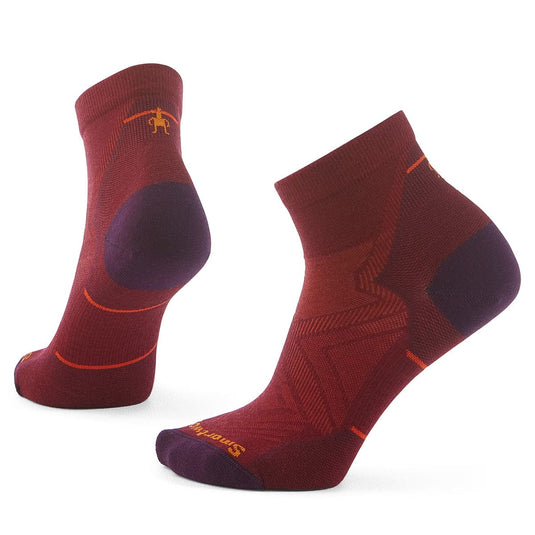 A pair of Smartwool women's run zero cushion ankle socks in red color with purple and orange accents.