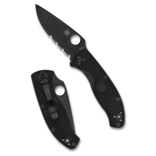 Black folding knife with textured handle on a white background
