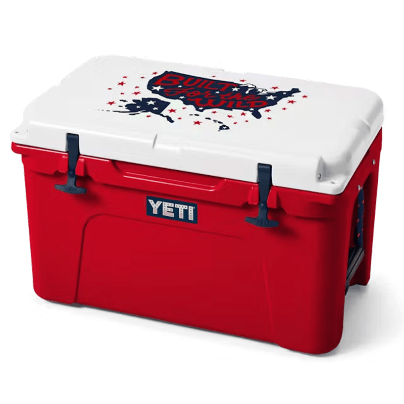 Load image into Gallery viewer, Red and white cooler with 'Built for the Wild' design and YETI logo.
