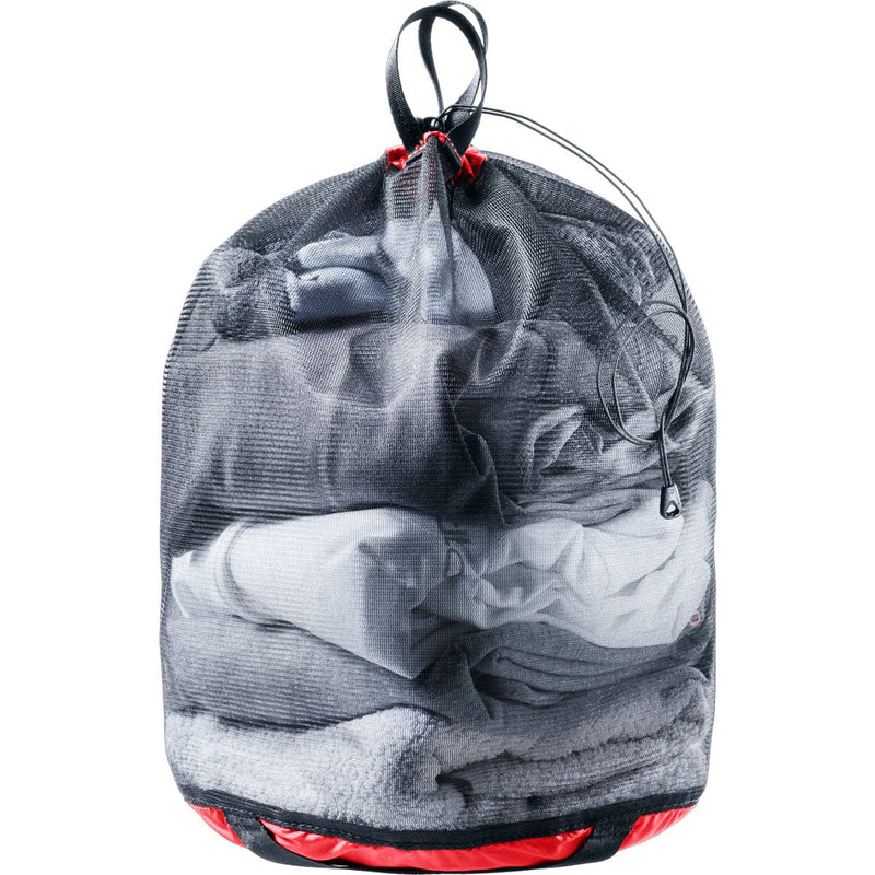 Load image into Gallery viewer, Drawstring bag filled with folded clothes on a white background
