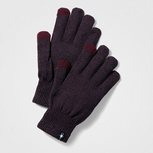 Pair of dark gray gloves with red tips on a light gray background