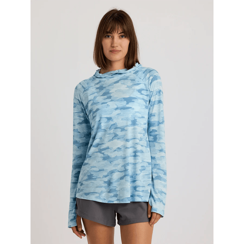Load image into Gallery viewer, Woman wearing a blue camouflage long-sleeve shirt on a light gray background
