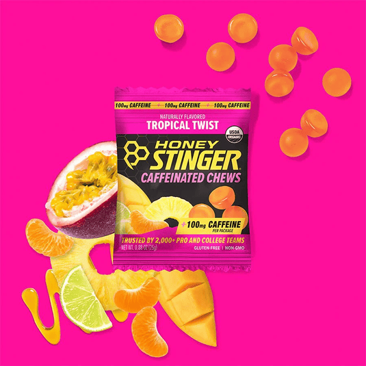 Honey Stinger caffeinated chews package with tropical fruit elements on a pink background
