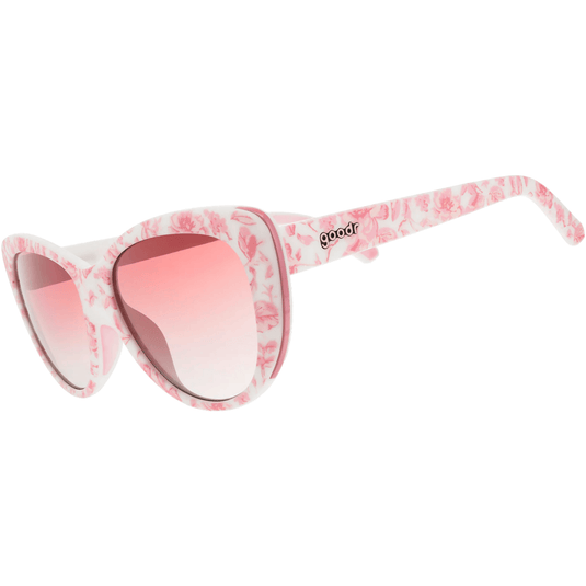 Floral-patterned sunglasses with pink lenses on a white background